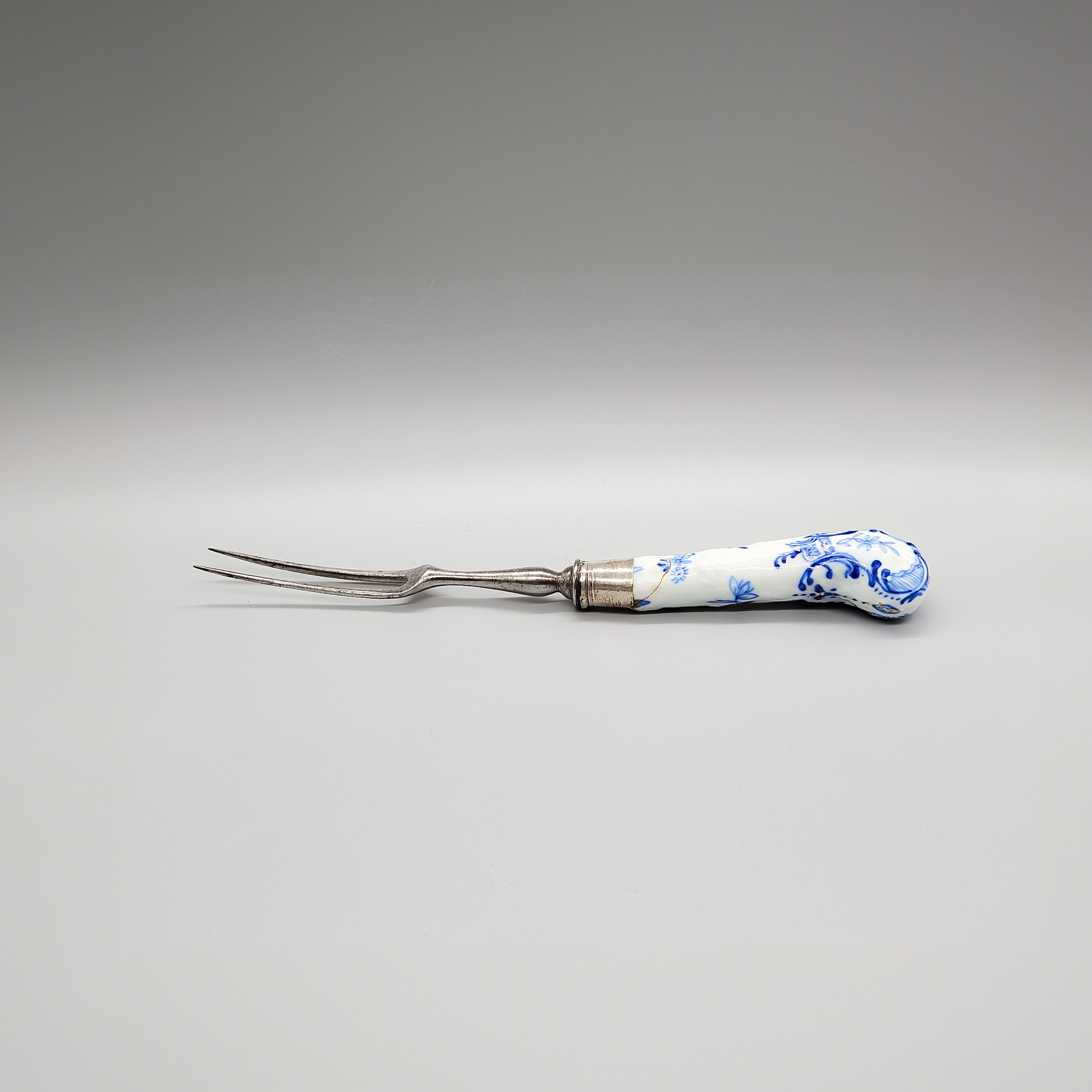 A Bow fork haft with scroll and garland moulded pistol shape, circa 1750-52