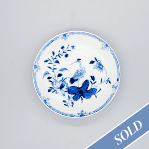 A rare Worcester saucer, painted in blue with the ‘Heron on a Floral Spray’ pattern, circa 1758-60
