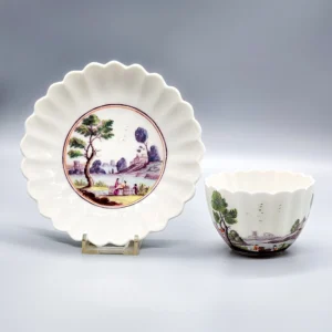A Chelsea lobed tea bowl and saucer decorated in Meissen style, circa 1753